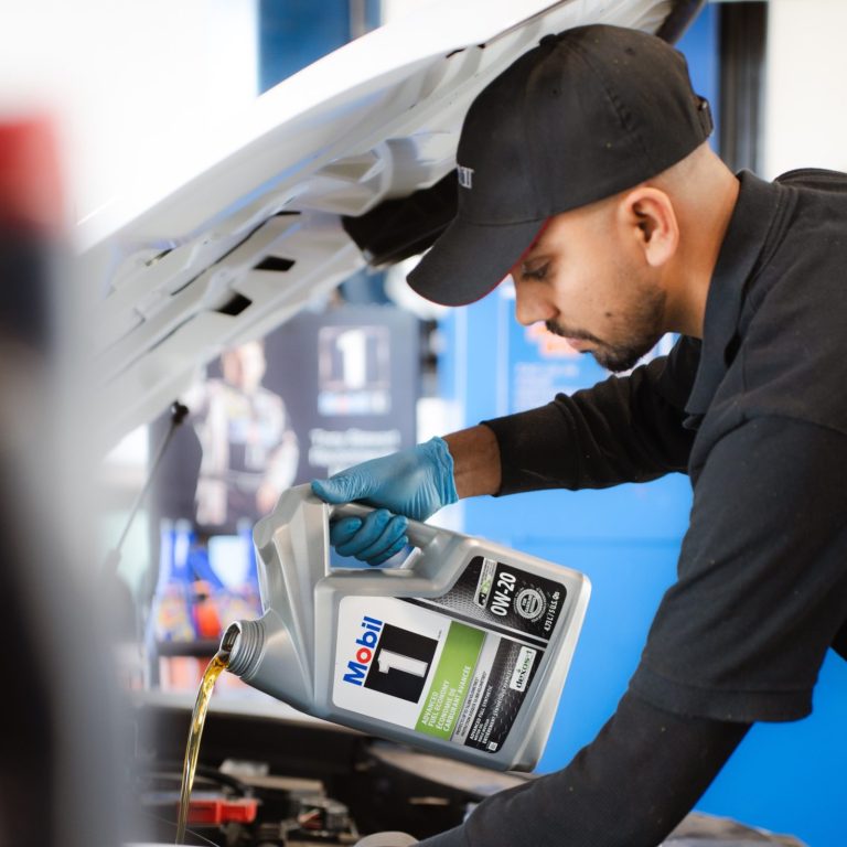 Certified technician performing oil change at Mobil 1 Lube Express Burnaby